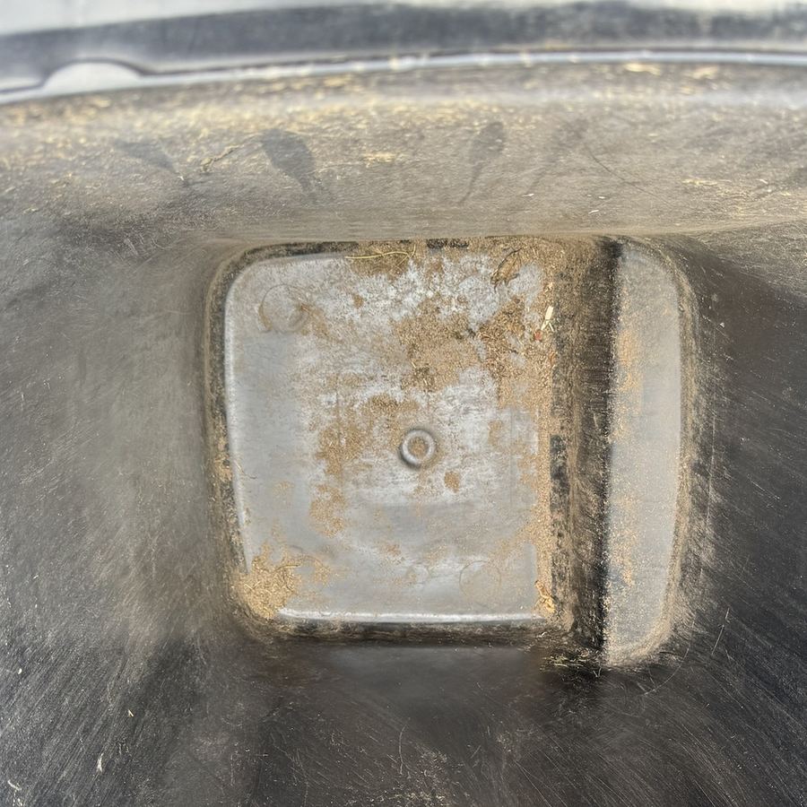 Dirty, stained bottom of a wheelie bin before cleaning